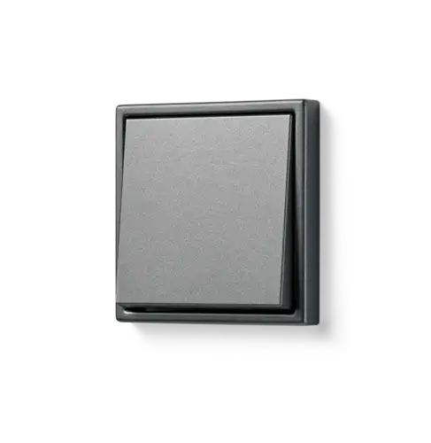Push-button in the LS 990 range made of metal in anthracite, photographed from a slight angle