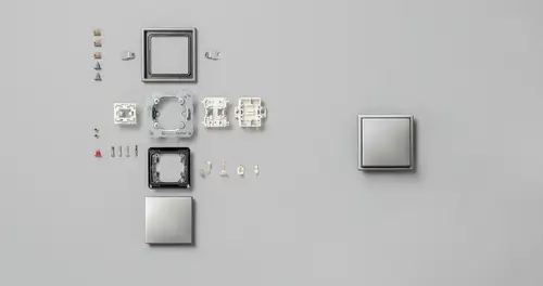 Taster im Programm LS 990 aus Metall. Darstellung der Einzelteile.