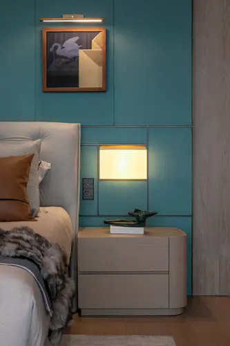 KNX push-button F 40 and Chinese Standard socket outlet in the LS 990 range in Dark, made of lacquered aluminium, installed in the room cut-out next to a modern box-spring bed and above a simple bedside chest of drawers.