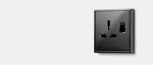 G + I socket in black, taken from a slight perspective against a grey background.