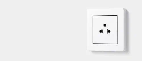 Thai standard socket in white, taken in perspective against a grey background.