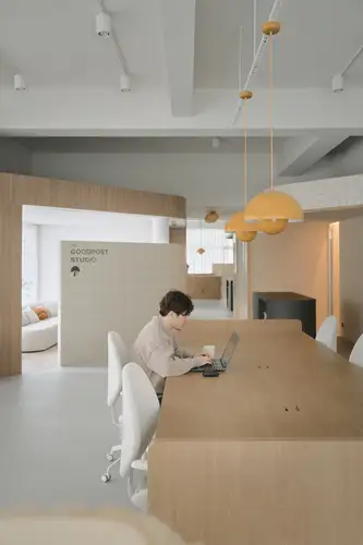 View of a person in the central work area at GoodPost Studio.