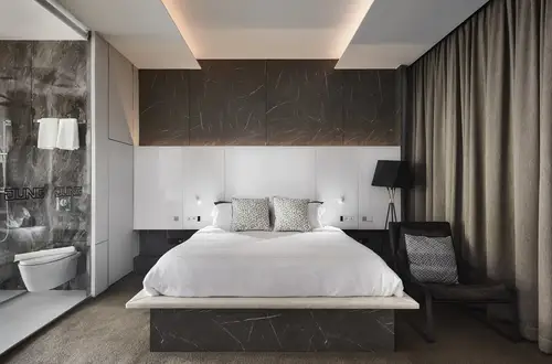 Photo shows a hotel room in which switches and systems from JUNG are installed.
