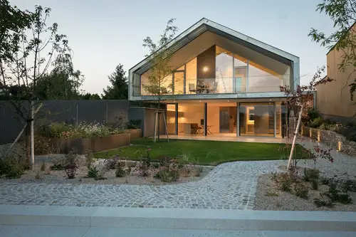 Exterior view of an illuminated detached house in the evening light.
© Architecture: formann ² puschmann, architekten zt-gmbh, Photo: Michael Baumgartner, KiTO