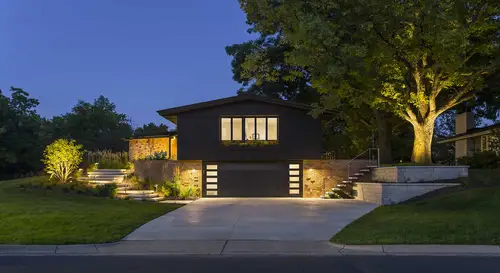 Exterior view of a detached house at night.
https://andrearugg.com/gallery/gardens/garage_driveway_night/