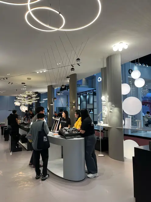 People looking at various JUNG products at the trade fair stand at Architect Expo.